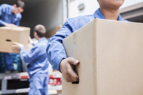 Moving boxes and furniture being loaded for a France removals quote