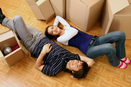 Removal team handling furniture in a French apartment
